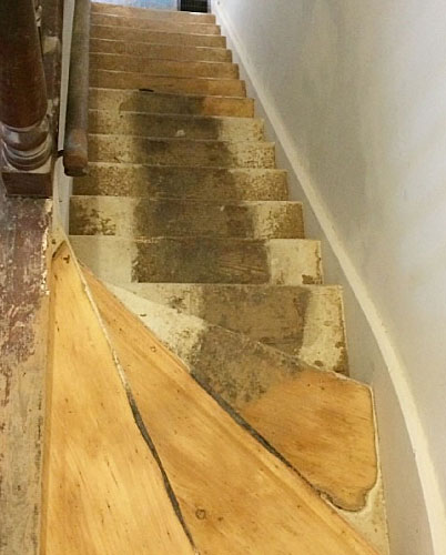 Worn hardwood floor before refinishing
